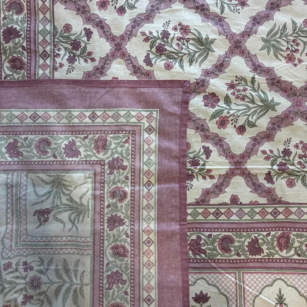 Close up of purple white Jaipur jaal floral hand block print pattern on 100% cotton bed sheet