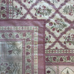 Close up of purple white Jaipur jaal floral hand block print pattern on 100% cotton bed sheet