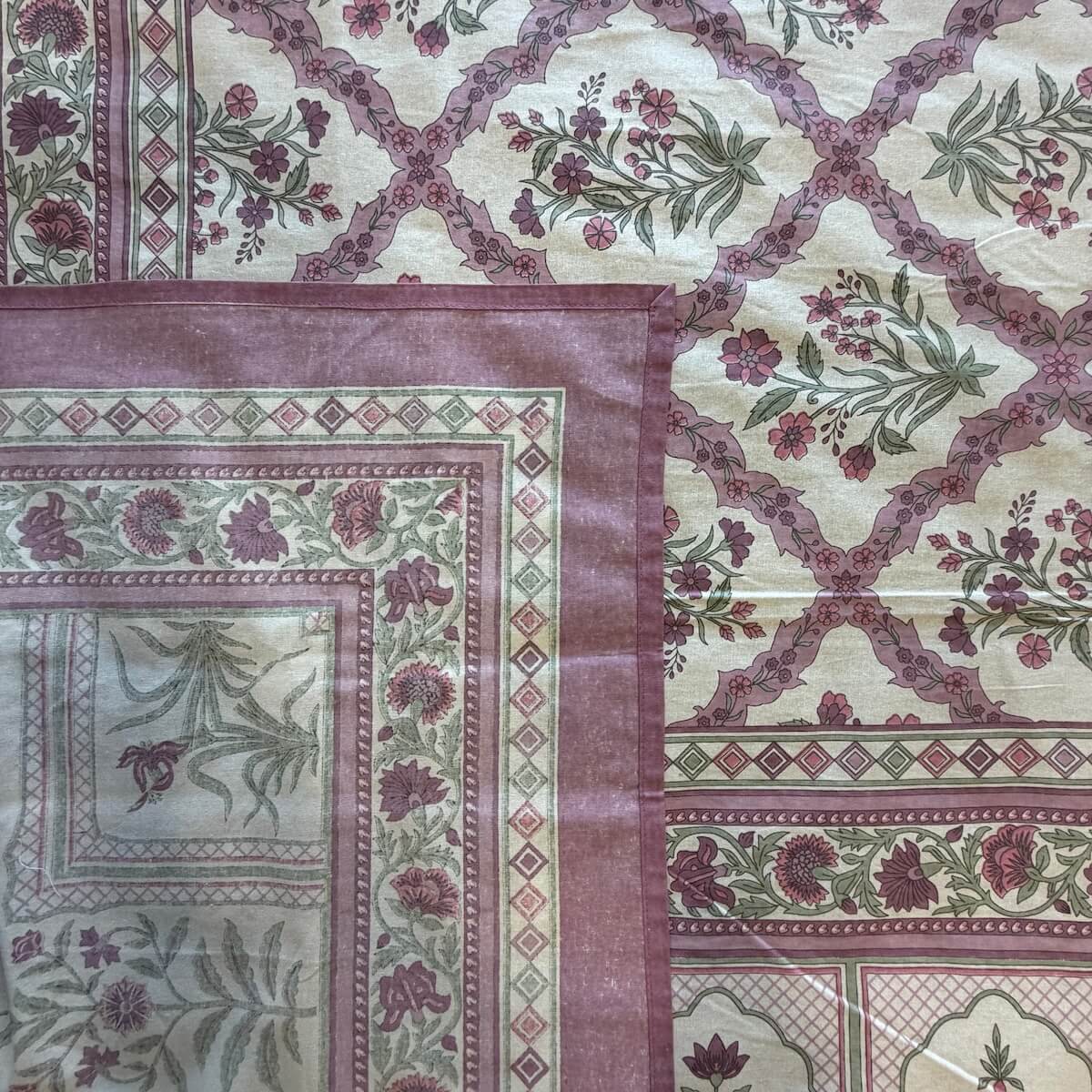 Close up of purple white Jaipur jaal floral hand block print pattern on 100% cotton bed sheet