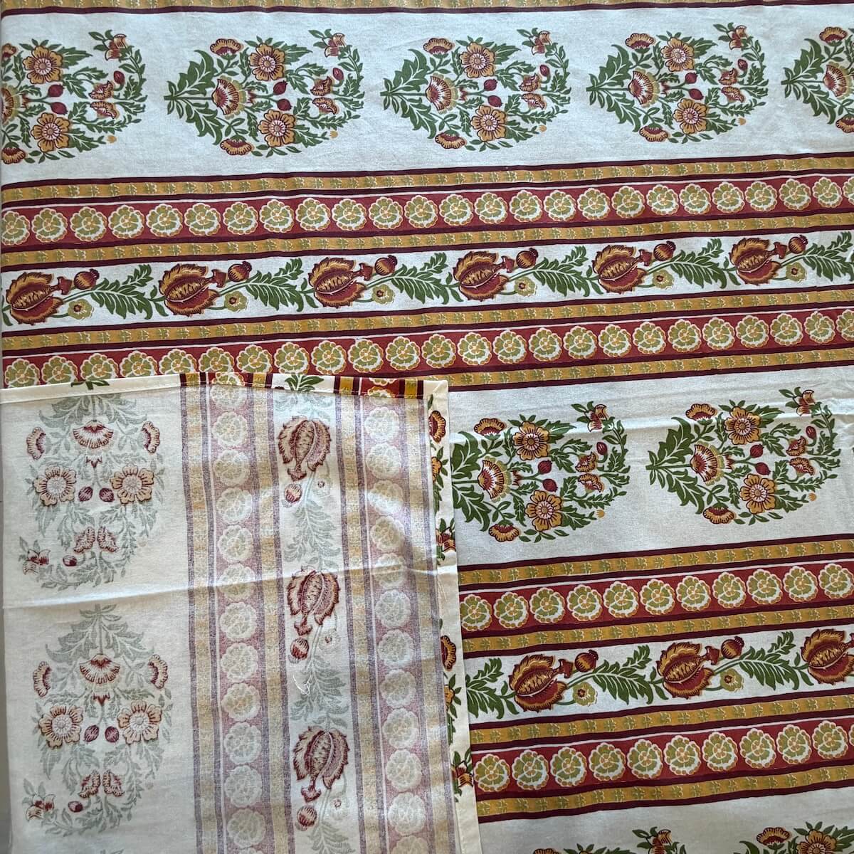 Close up of white Jaipur stripe boota hand block print pattern on 100% cotton bed sheet