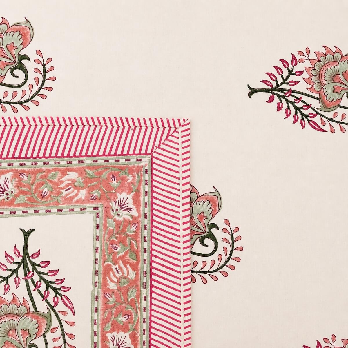 Close up of cream pink Jaipur boota floral hand block print pattern on 100% cotton bed sheet