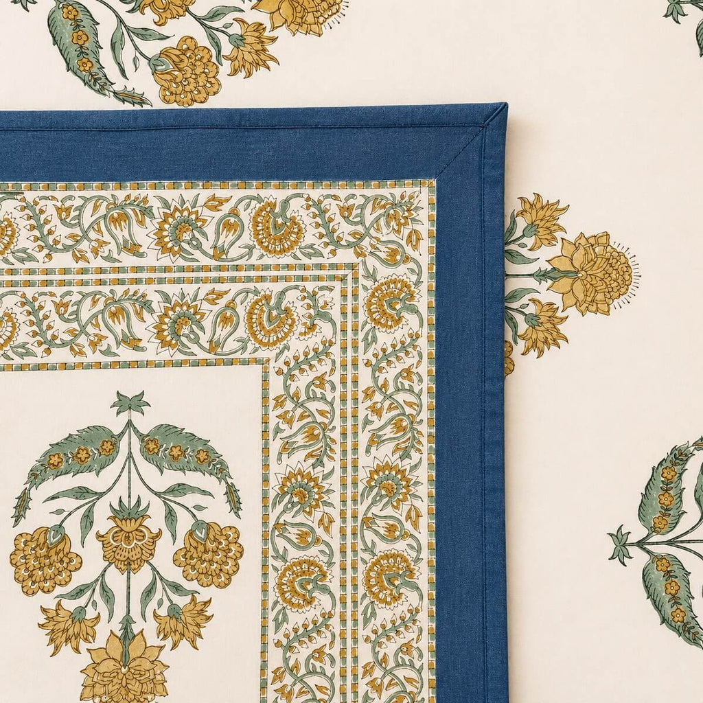 Close up of cream blue Jaipur boota floral hand block print pattern on 100% cotton bed sheet