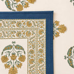 Close up of cream blue Jaipur boota floral hand block print pattern on 100% cotton bed sheet