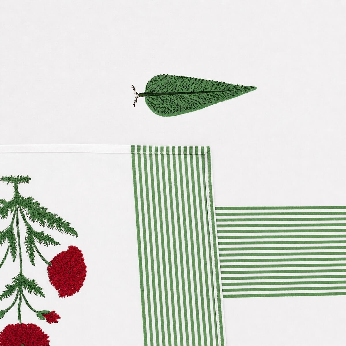 Close up of white green stripe red floral hand block print pattern on 100% cotton bed sheet