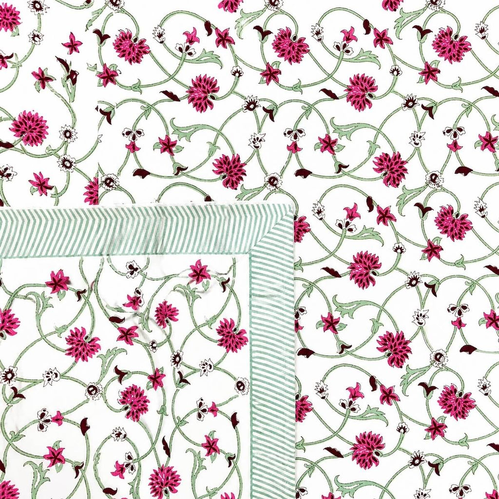 Close up of white pink jaal vine floral hand block print pattern on 100% cotton bed sheet