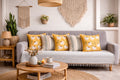 Living room with a gray sofa, yellow and patterned cushions, and decorative items.