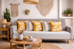 Living room with a gray sofa, yellow and patterned cushions, and decorative items.