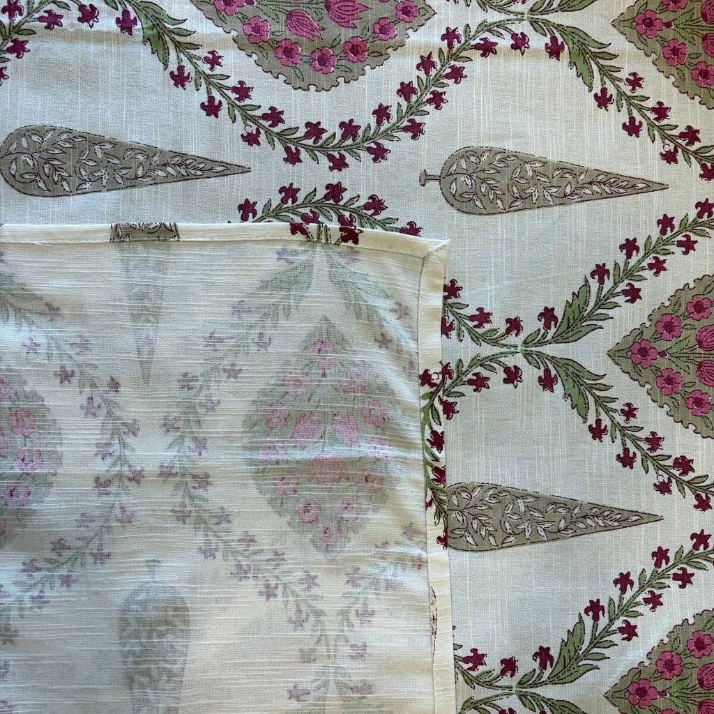 Close up of off white pink Jaipur diamond jaal hand block print pattern on 100% cotton bed sheet
