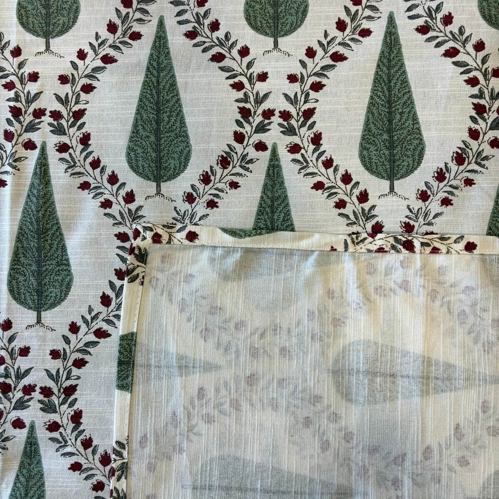 Close up of off white green Jaipur cypress jaal hand block print pattern on 100% cotton bed sheet